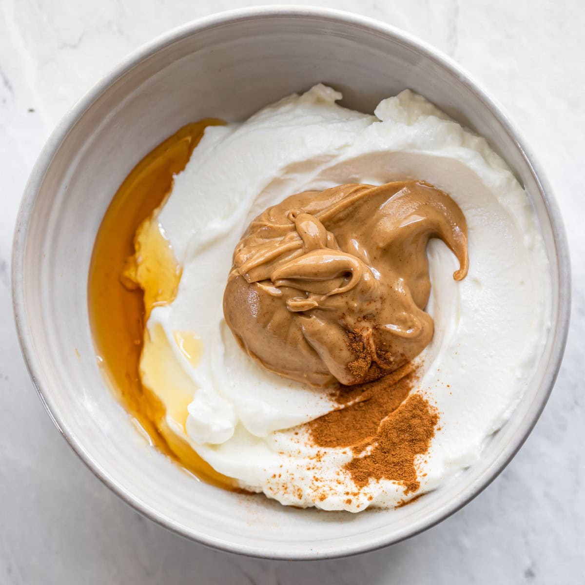 Peanut butter dip ingredients in a bowl before mixing.