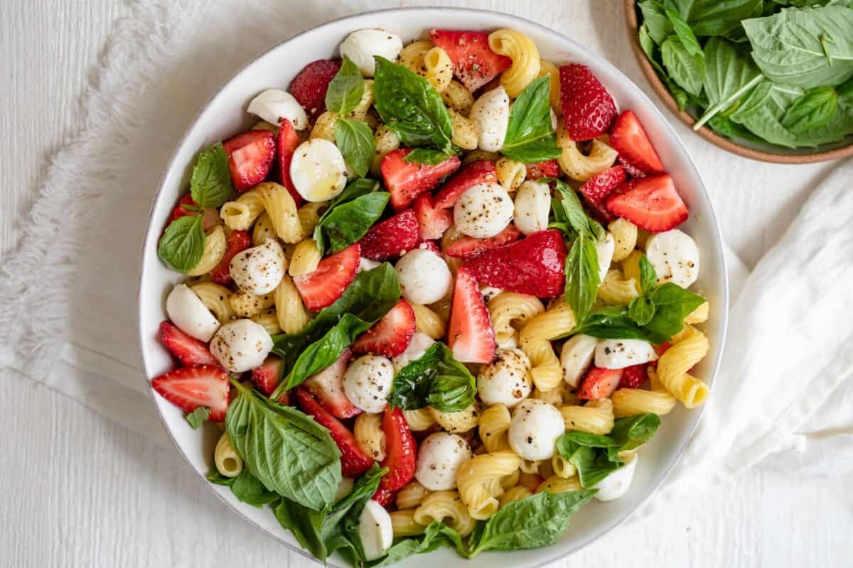 Strawberry caprese salad in a large serving bowl after fully assembled. 