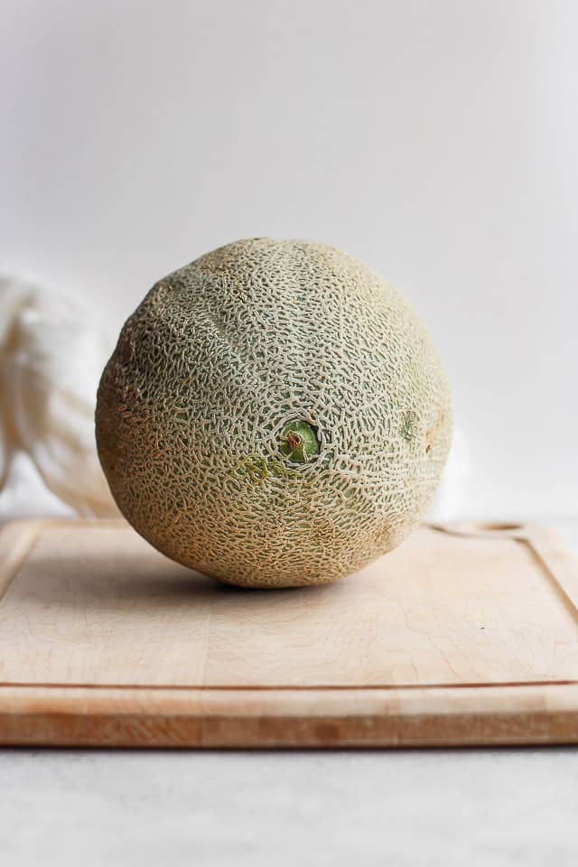 Large cantaloupe on cuttingboard