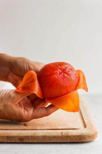 How to peel and seed a tomato - showing peeled tomato on cutting board