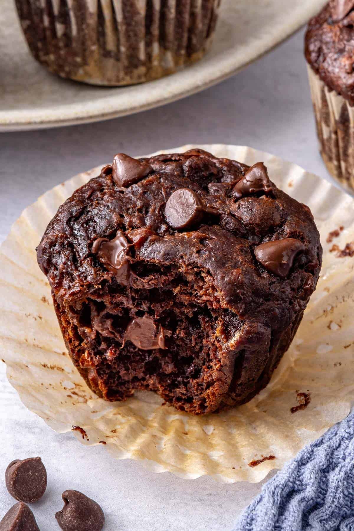 Close shot of one muffin with a bite taken.
