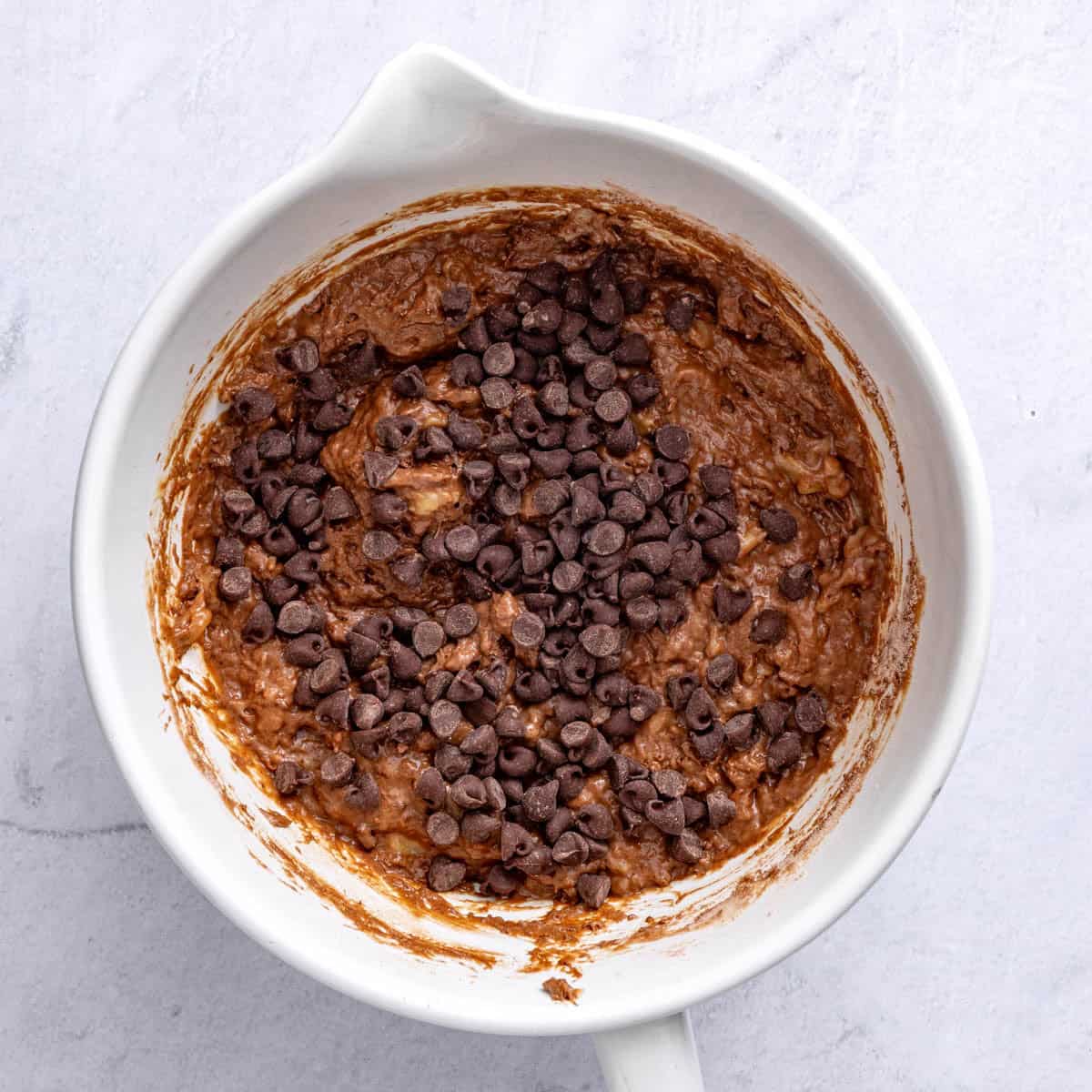 Chocolate chips added to the bowl.
