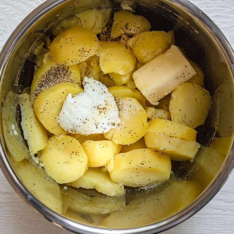 Other mashed potato ingredients added on top of the potatoes.