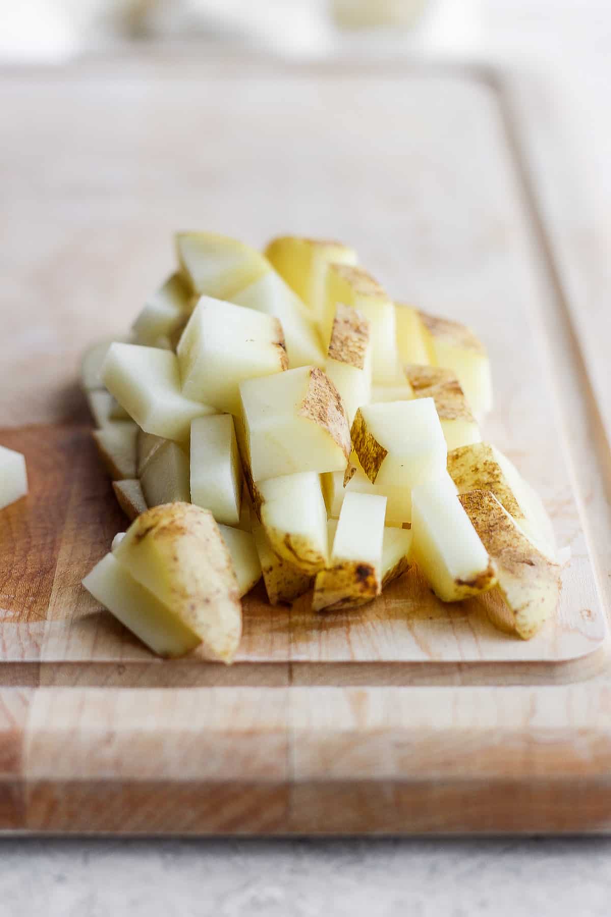 Cubed potatoes cut on a cutting board