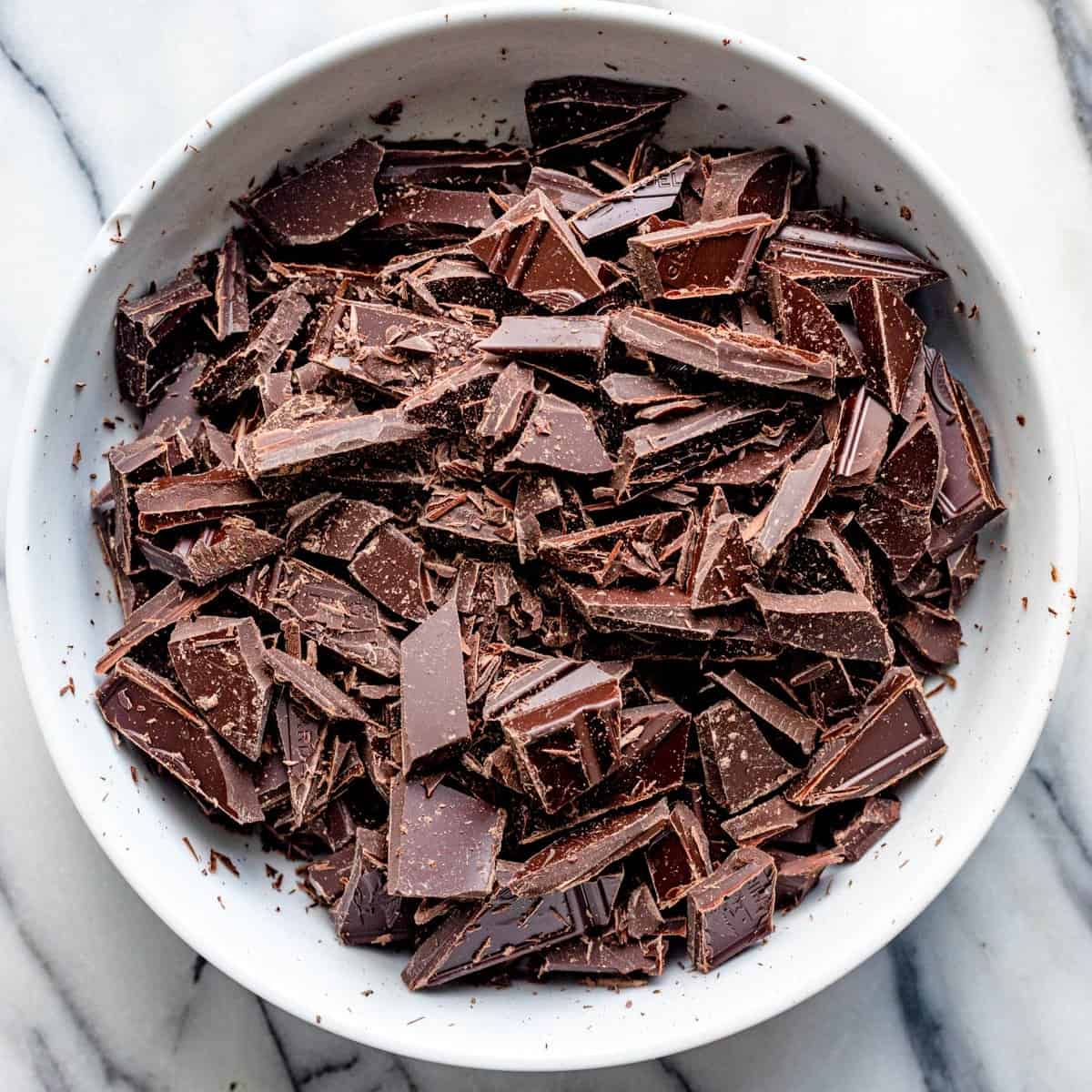 Chopped dark chocolate in a bowl.
