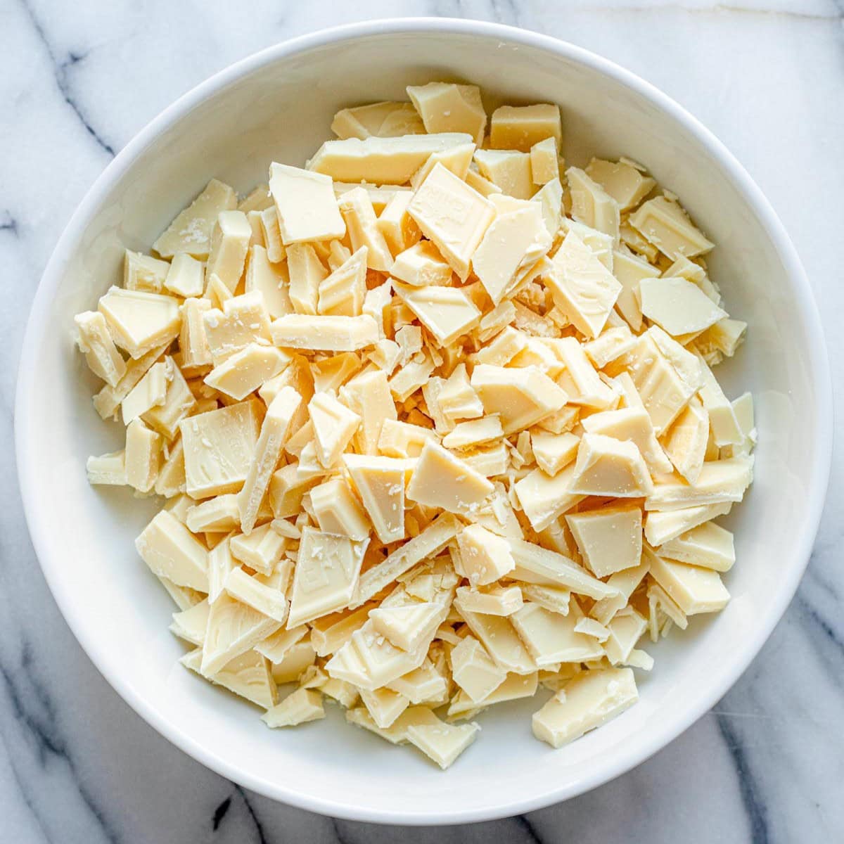 Chopped white chocolate in a bowl.
