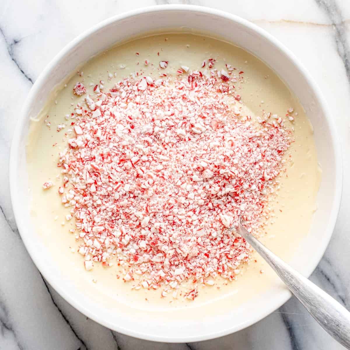Peppermint pieces placed on top of the melted white chocolate.