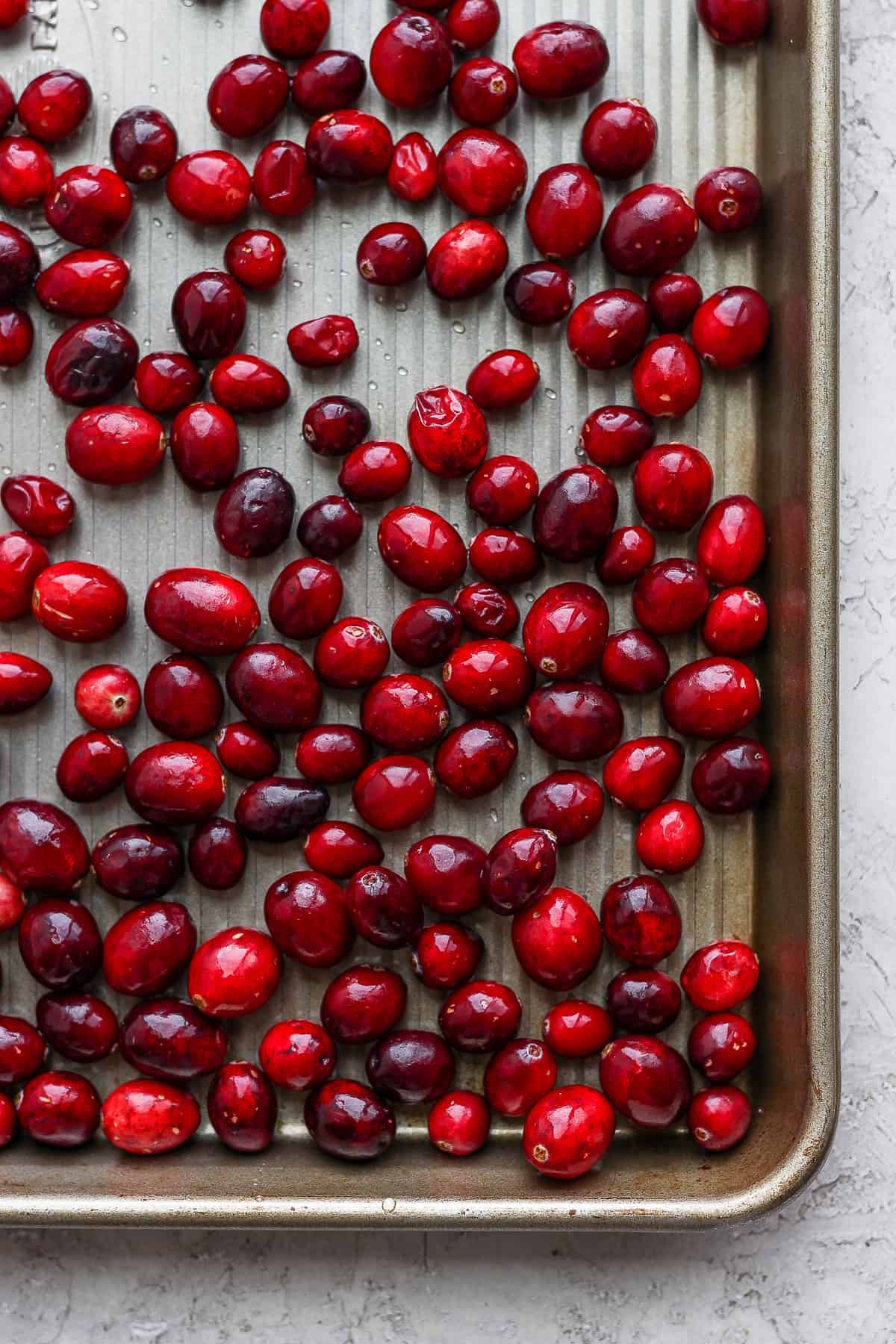 Close up shot of the cranberries frozen on a baking tray