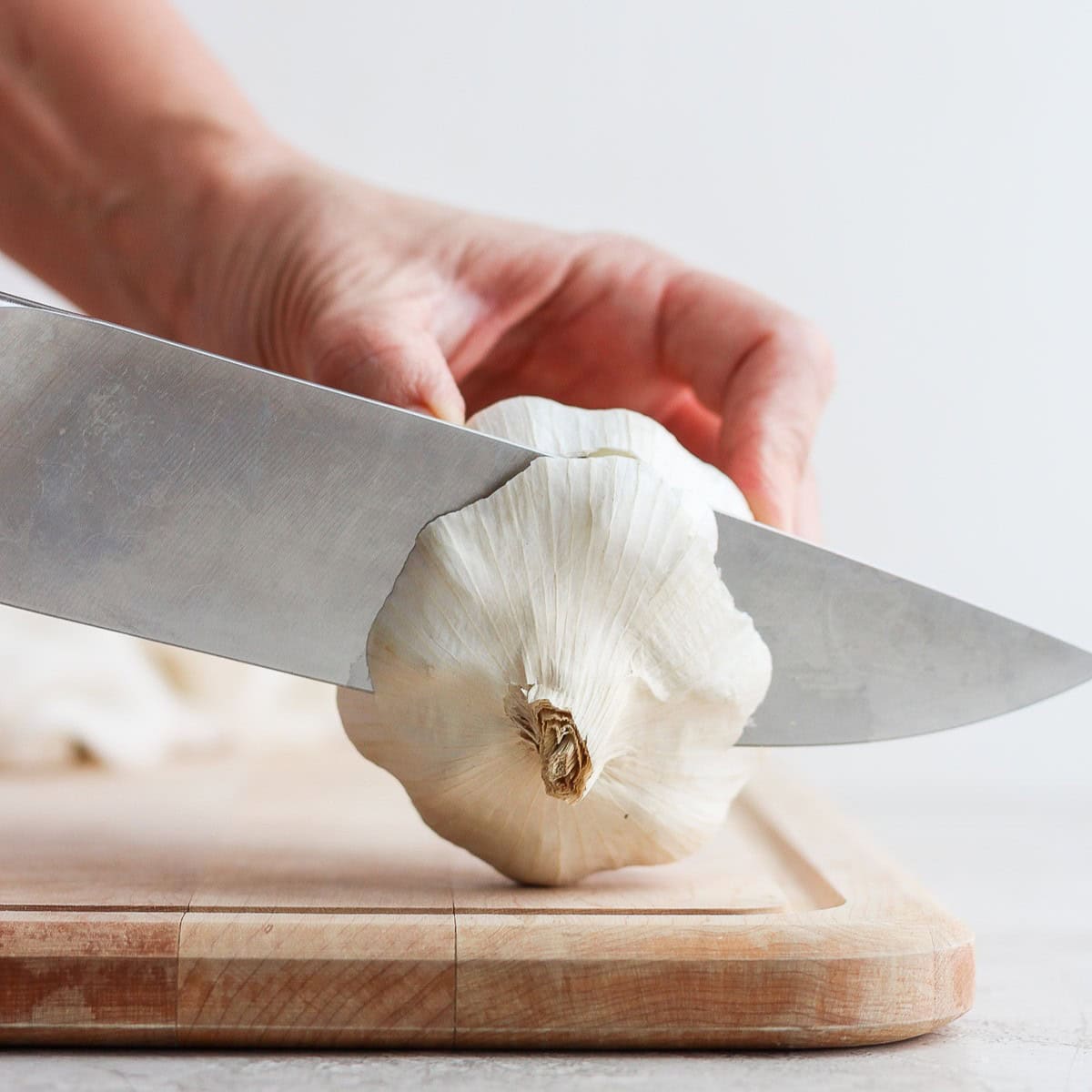 Cut garlic to expose the tops of the garlic cloves.