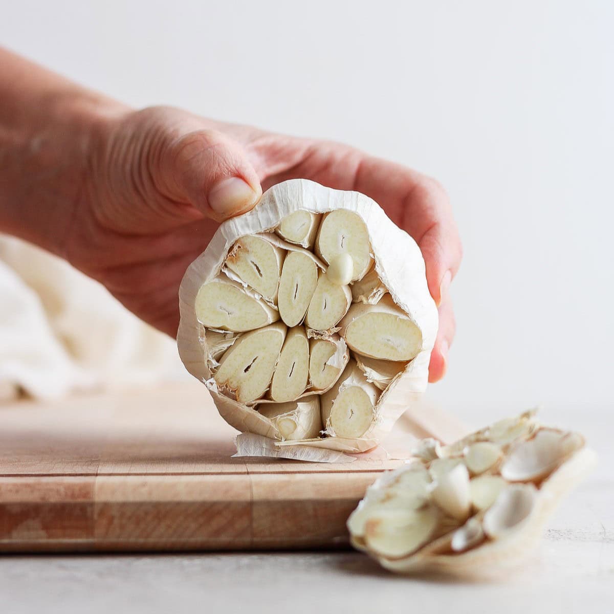 Removing any loose papery outer layers.