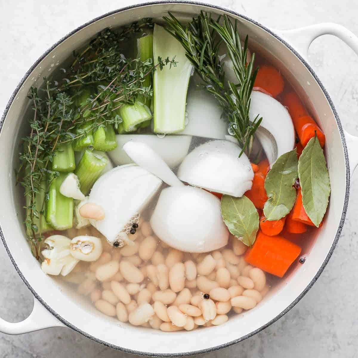 Water added to the pot, covering three-quarters of the vegetables.