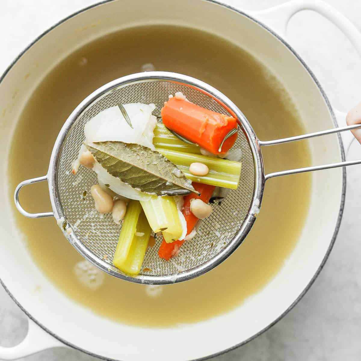 Removing all floating pieces or vegetables.