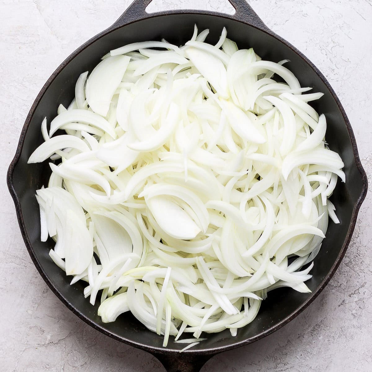 Onions in pan before caramelizing.