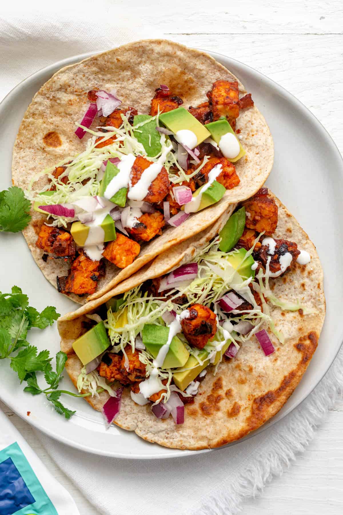 Close up shot of tempeh tacos with toppings