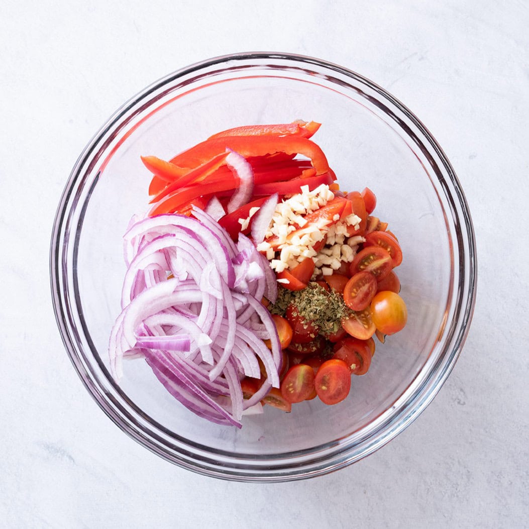 Veggies, feta, and olive oil in bowl.