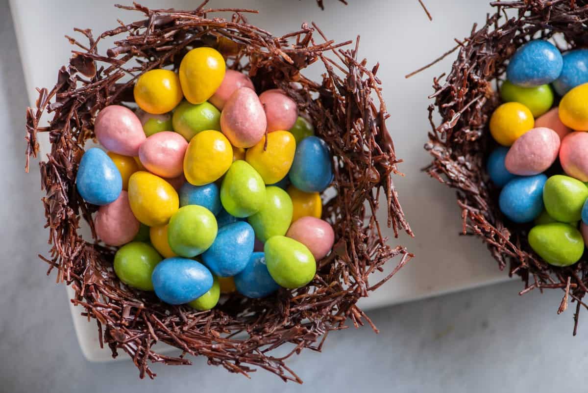Two chocolate nests filled with egg candies. 