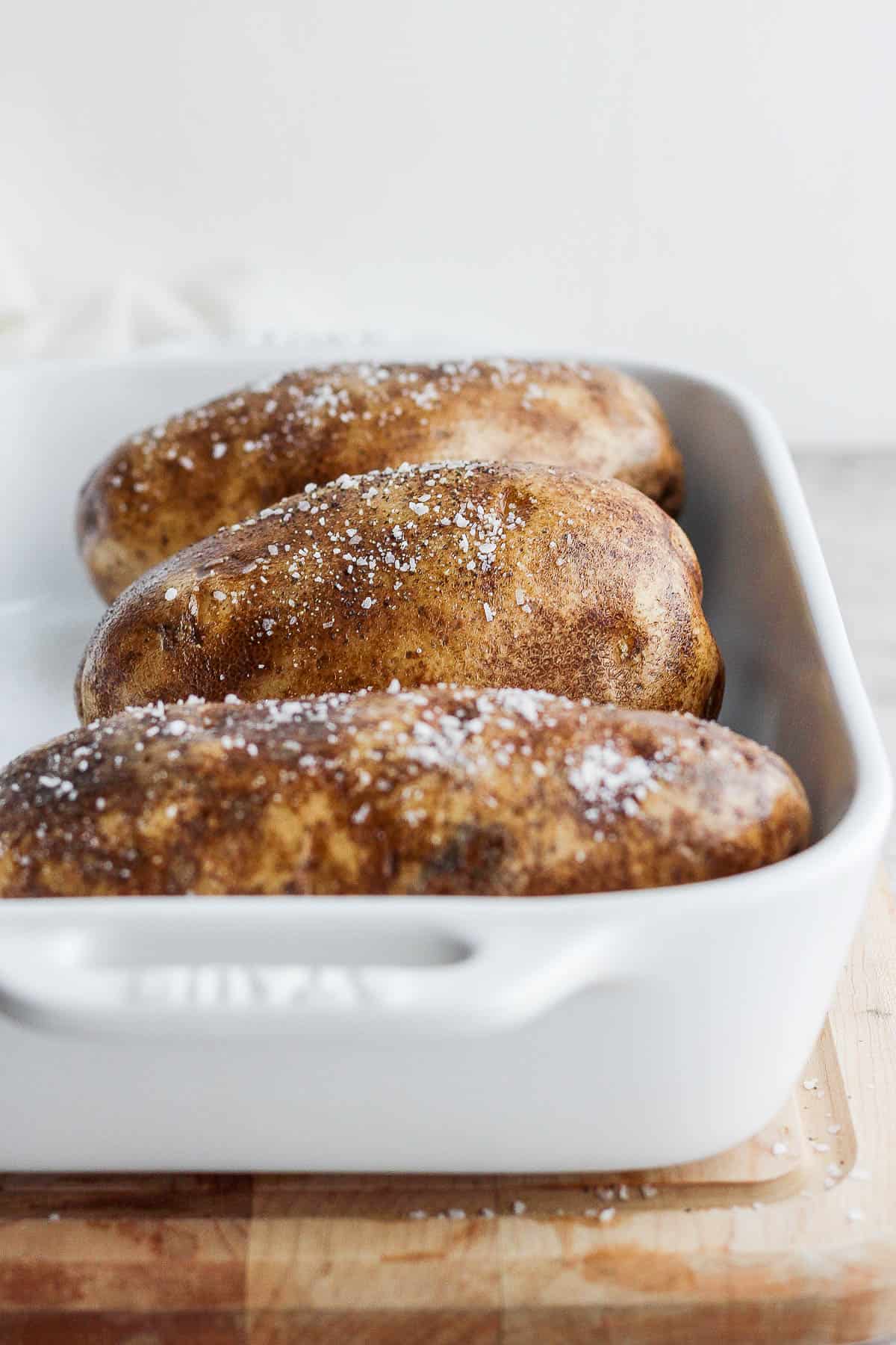 Russel potatoes in a baking dish before baking