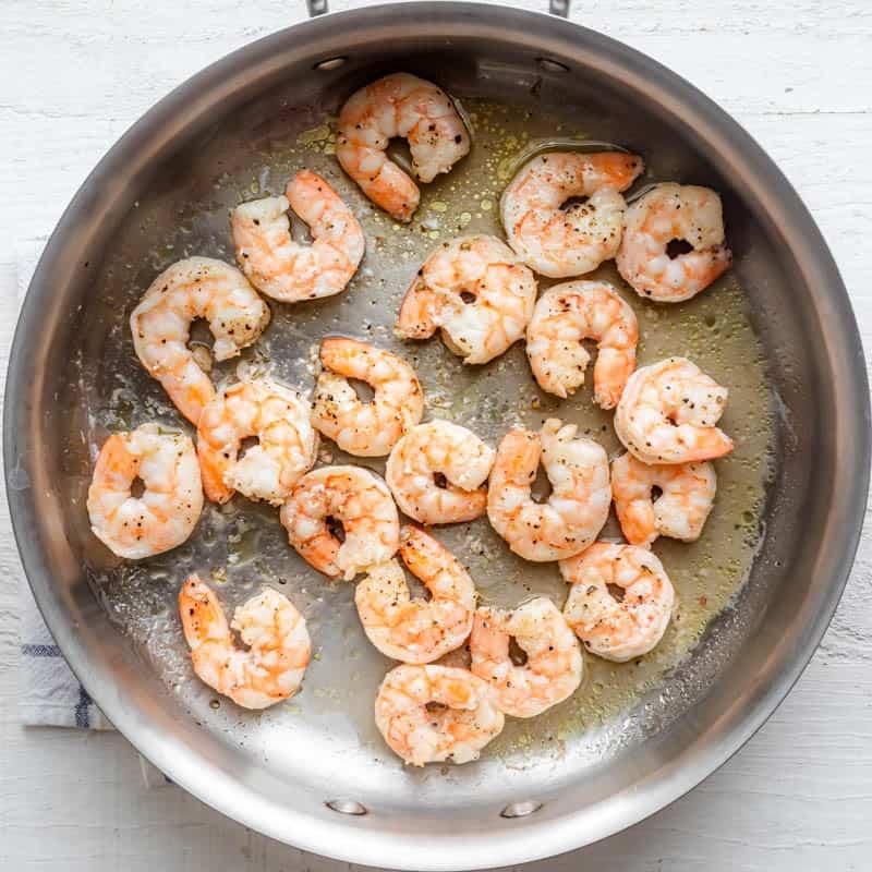 Shrimp in pan after cooking halfway.