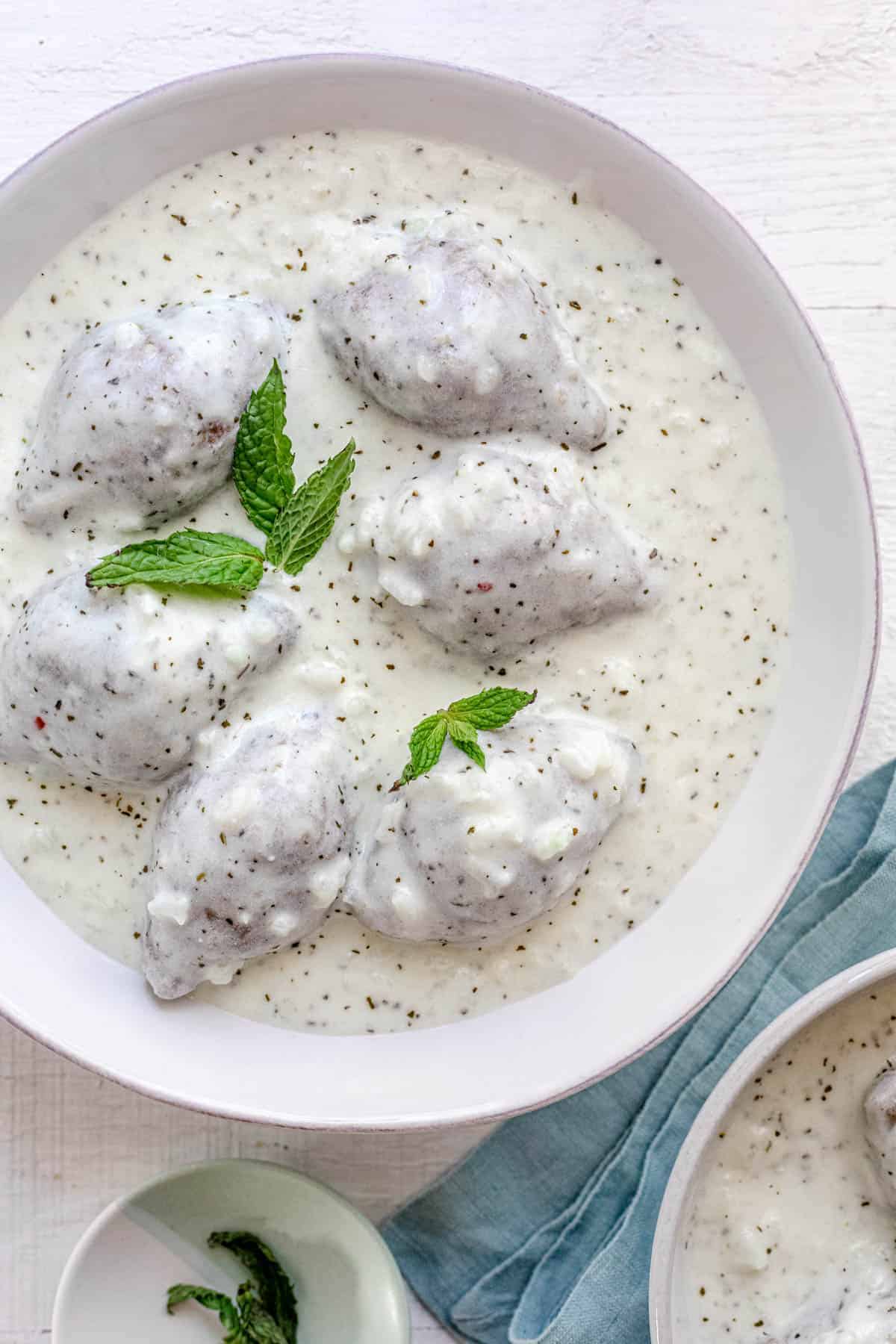 Kibbeh bi labanieh - traditional Middle Eastern dish in a large bowl of yogurt sauce