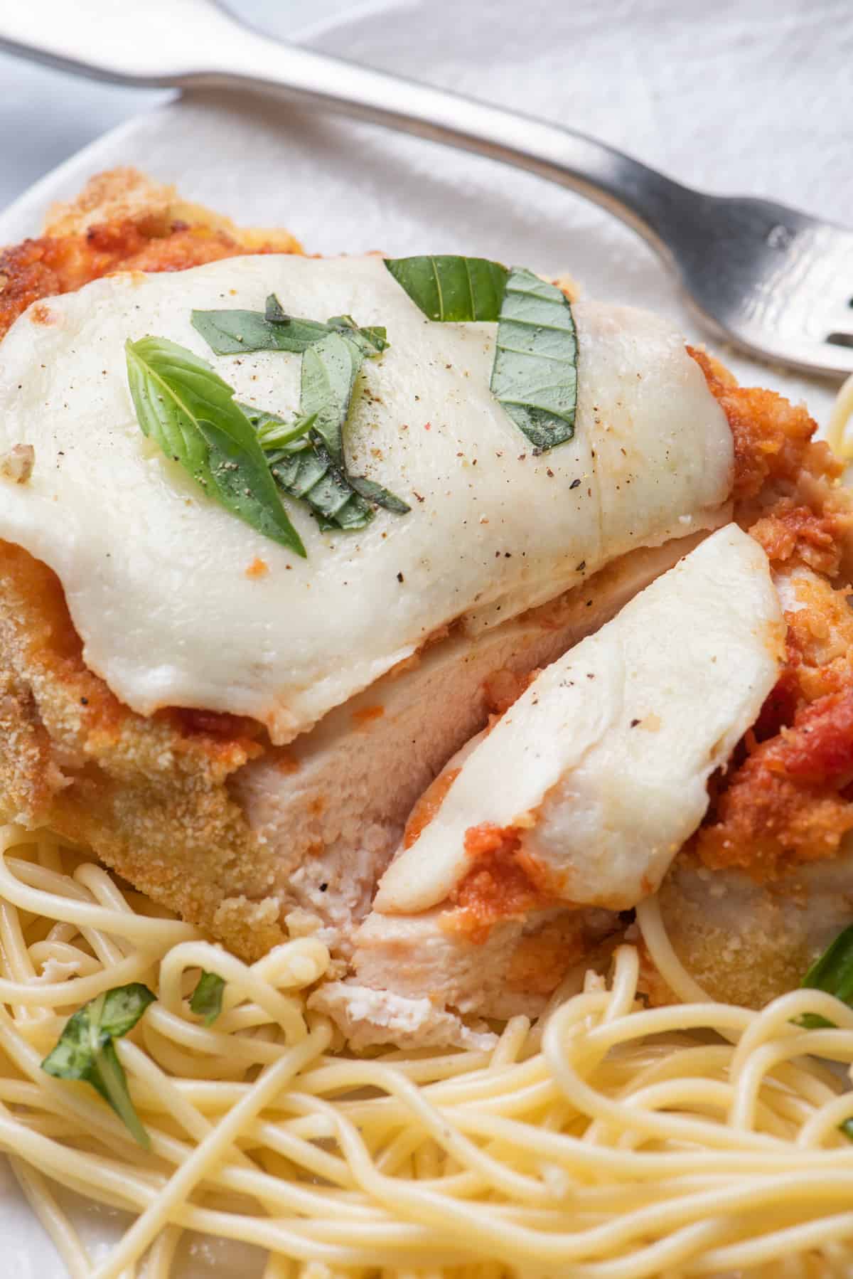 Close up shot of chicken parmesan cut in half