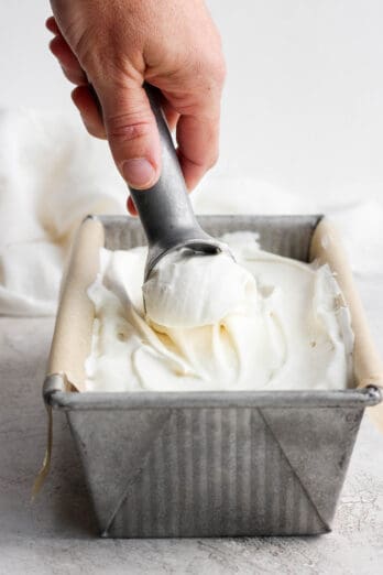 Ice cream scooper scooping homemade ice cream from a loaf pan