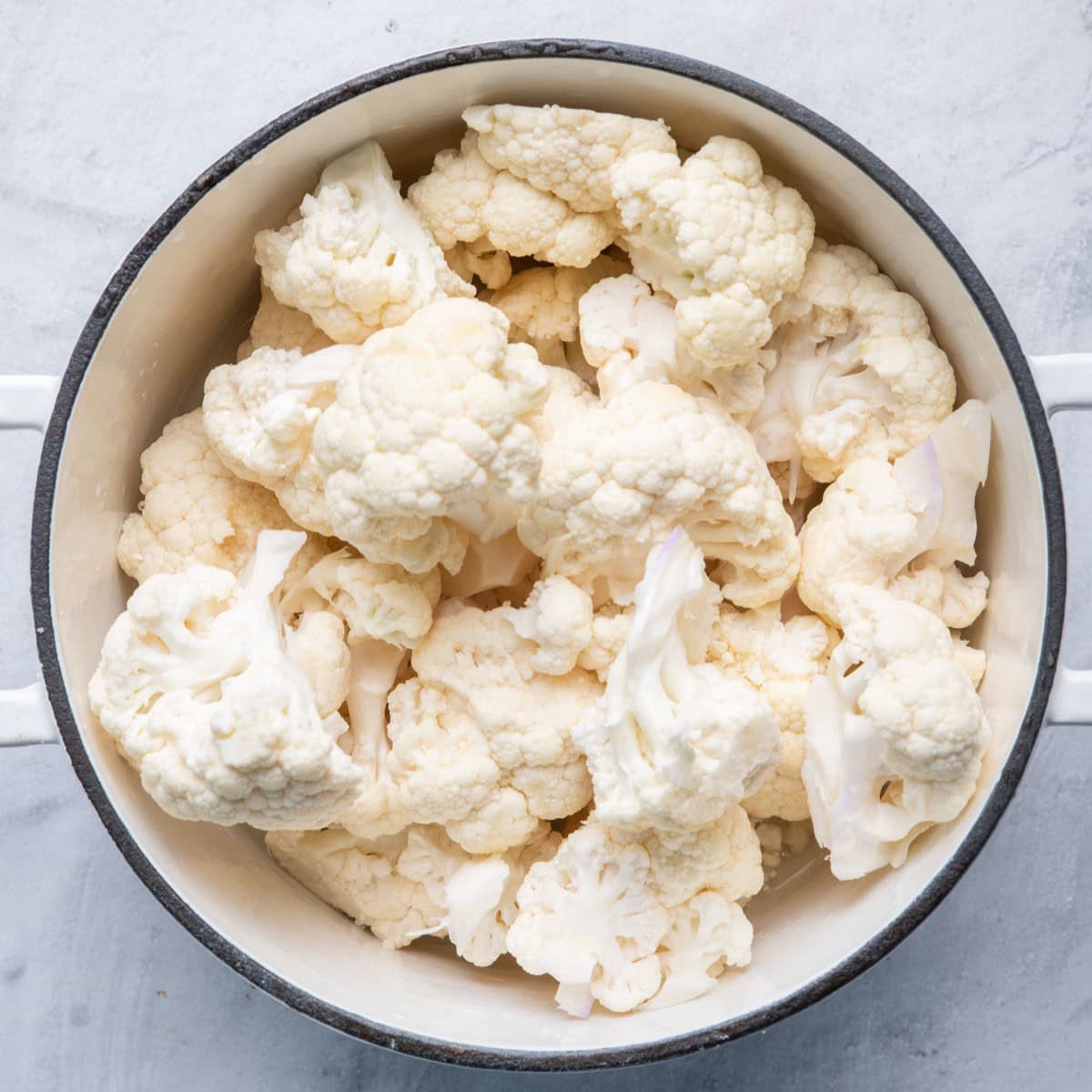 Cauliflower florets in pot before cooking.