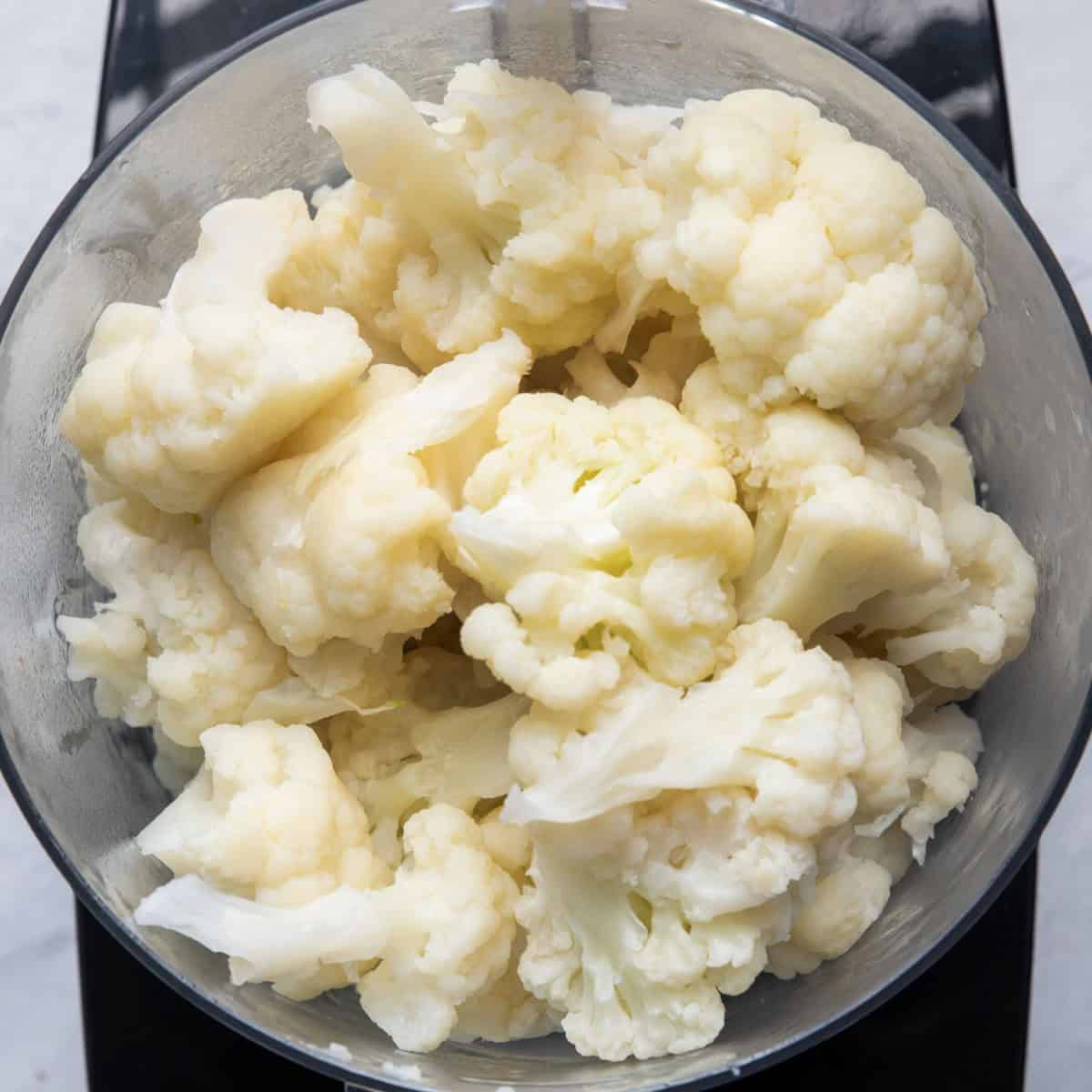 Cauliflower florets transferred to food processor.