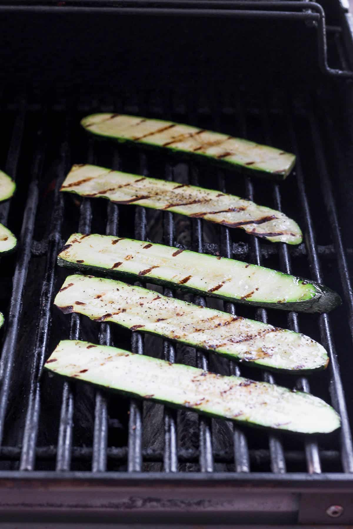 Grilled zucchini slices on outdoor grill
