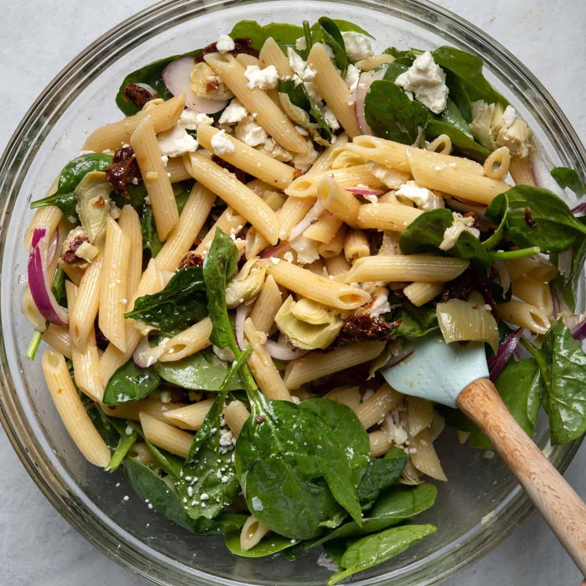 Mixing salad together.