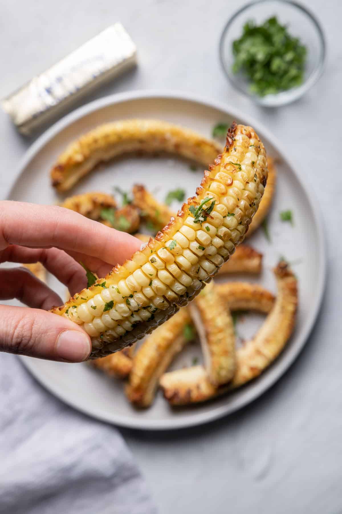 Hand holding corn ribs to show close up how it looks