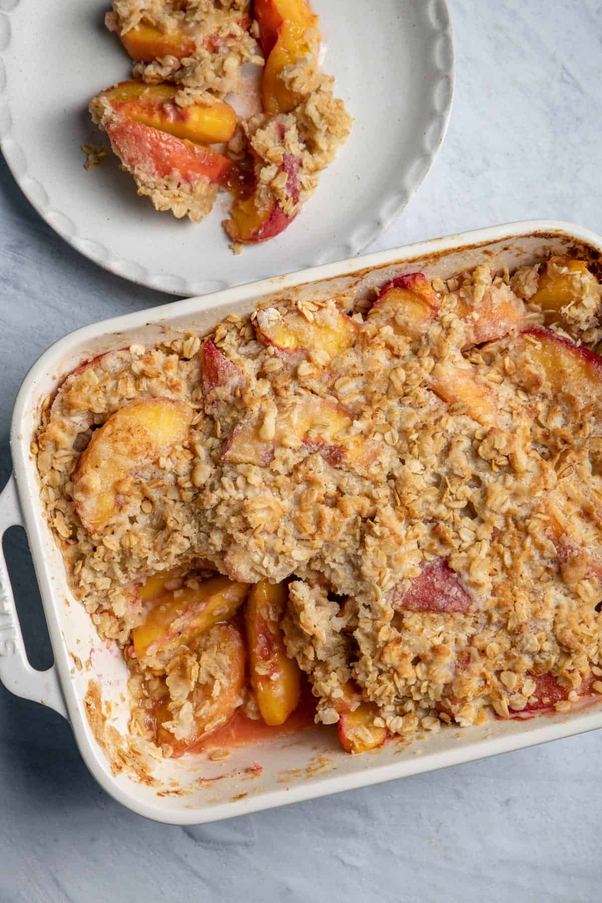 Large baking dish of the peach crisp and some served on the side.