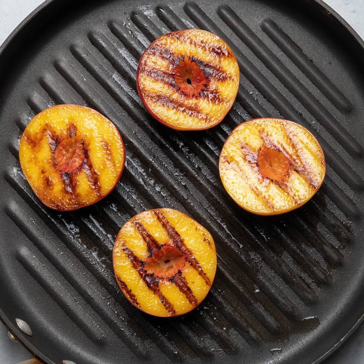 Peaches flipped showing grill marks.