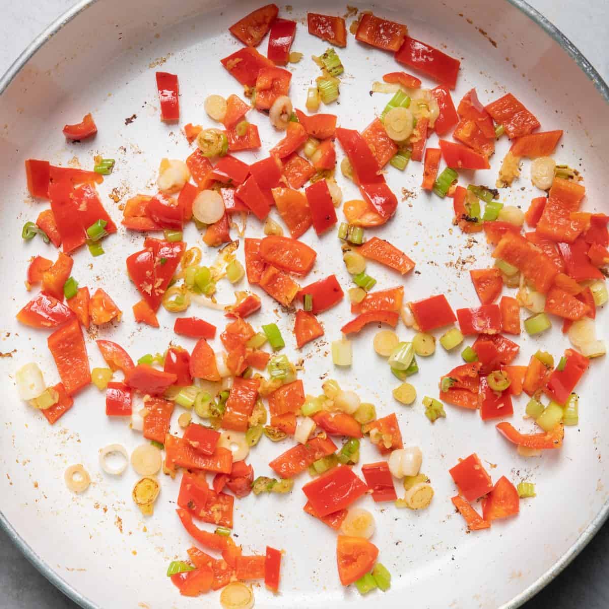 Cooked scallions, peppers and carrots.
