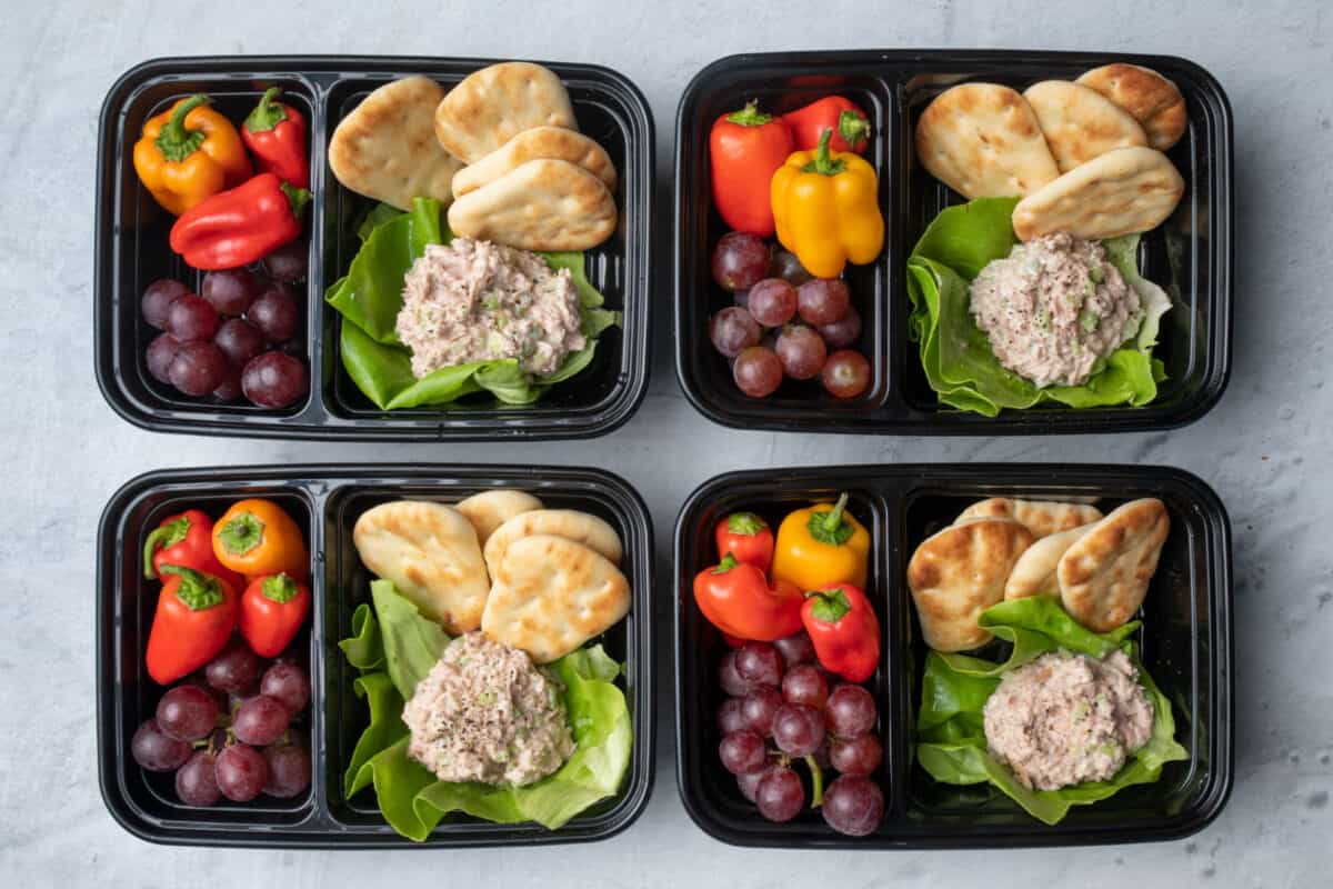 4 tuna salad meal prep containers with pita, peppers and graps