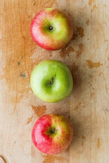 Top down view of 3 different colored whole apples.