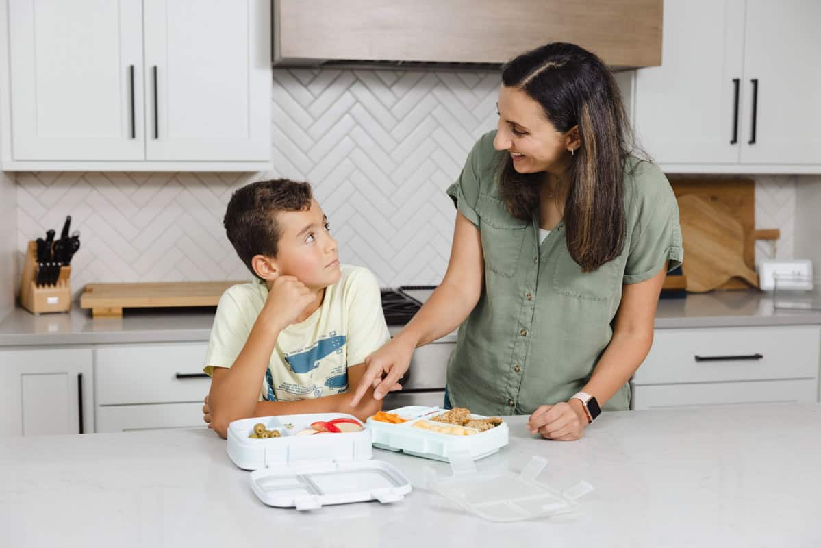 Yumna with son (Adam) pointing at lunchboxes
