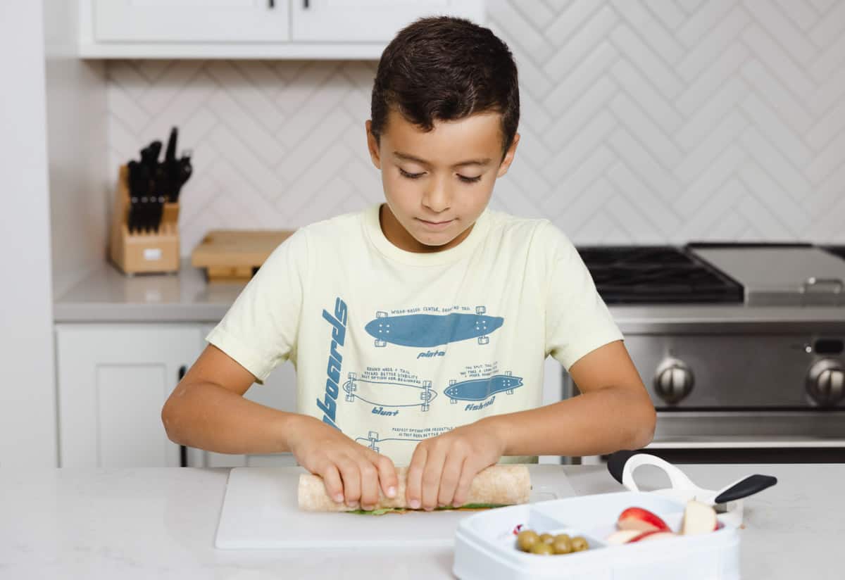 Adam wrapping sandwich to put in lunchbox
