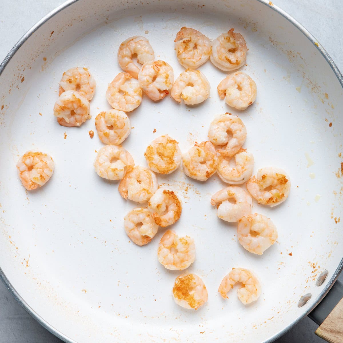 Cooked shrimp in large sautรฉ pan.