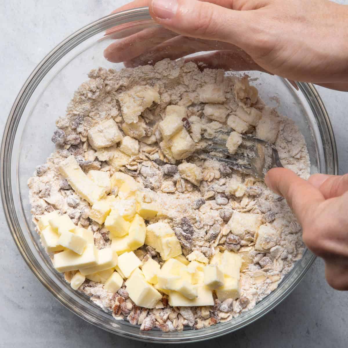 Fork cutting butter into the dry ingredients.