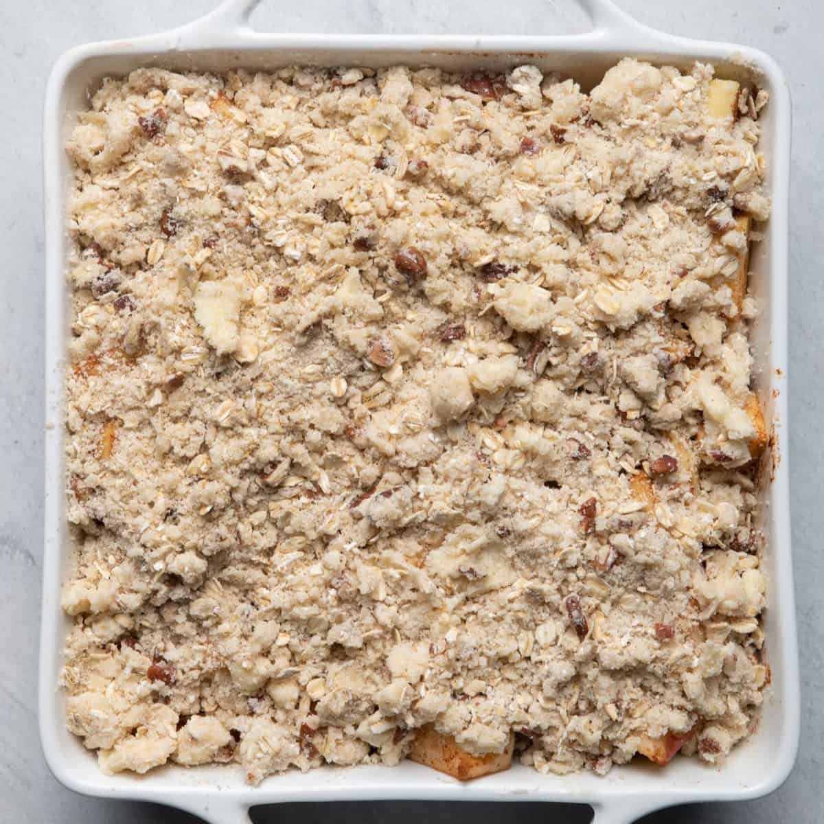 Baking dish with filling and crisp on top before baking.