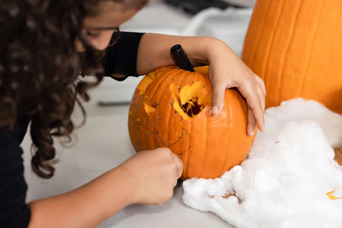 Carine carving pumpkin with tools