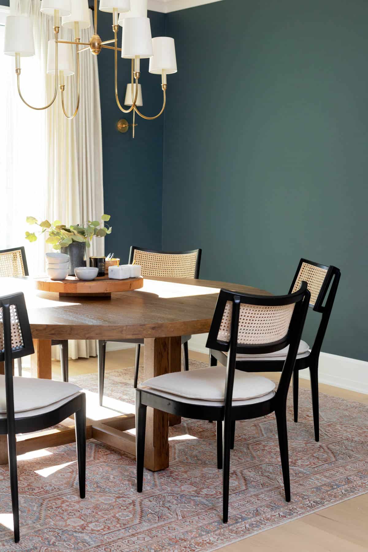 View of the dining room with the chairs and rug and green wall