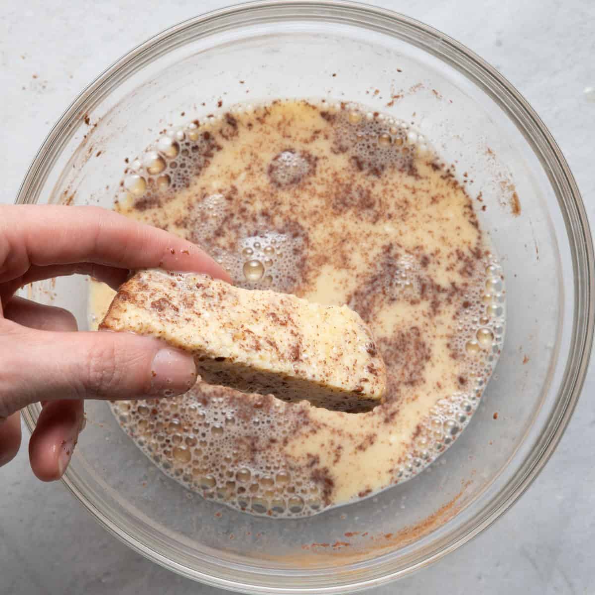 Dipping bread into egg mixture.