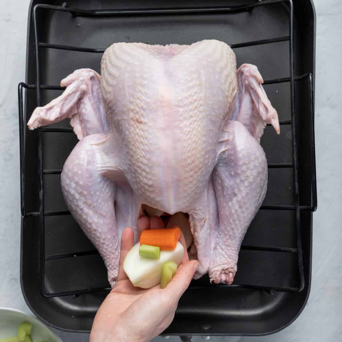 Stuff onions, celery and carrot inside turkey crevice.