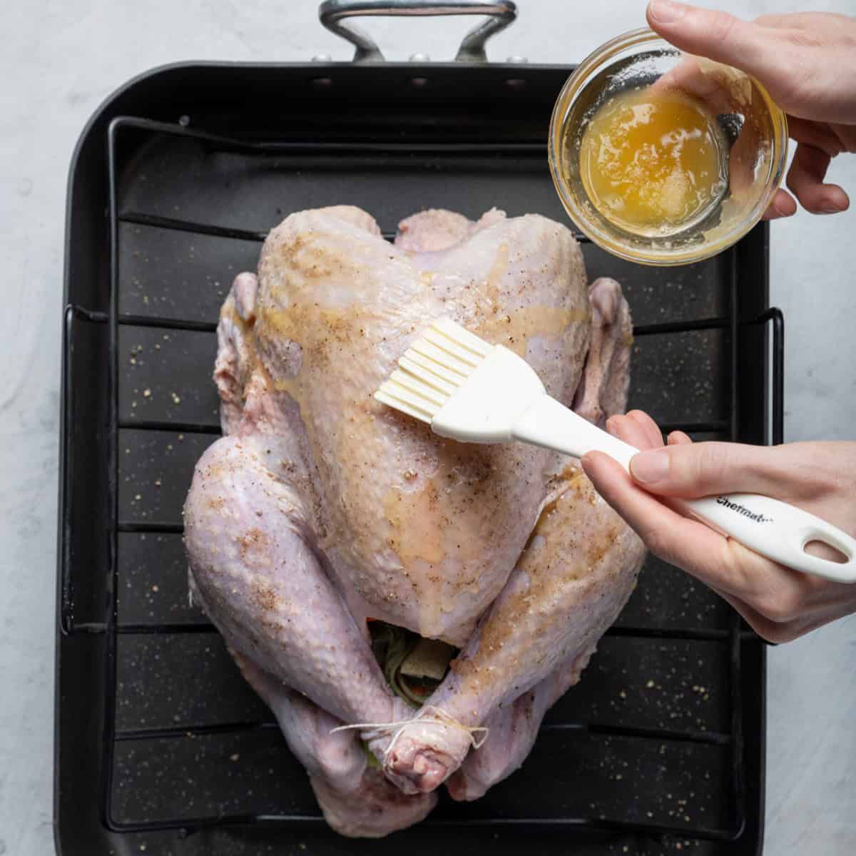 Brush butter on turkey.