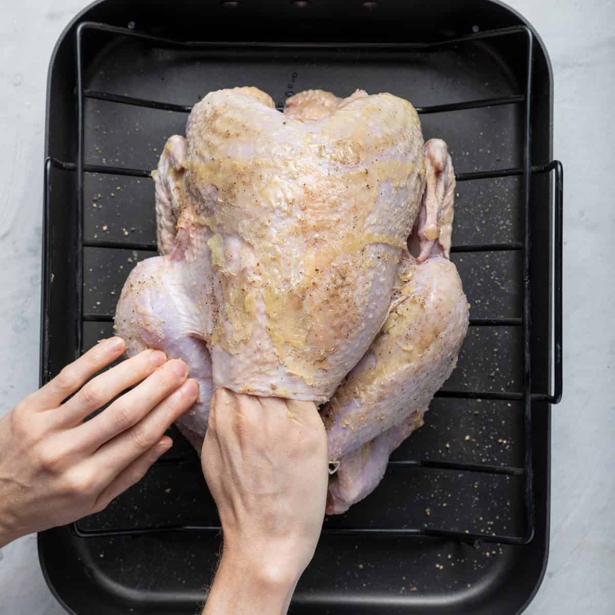 Use hands to lift skin and rub butter underneath skin.