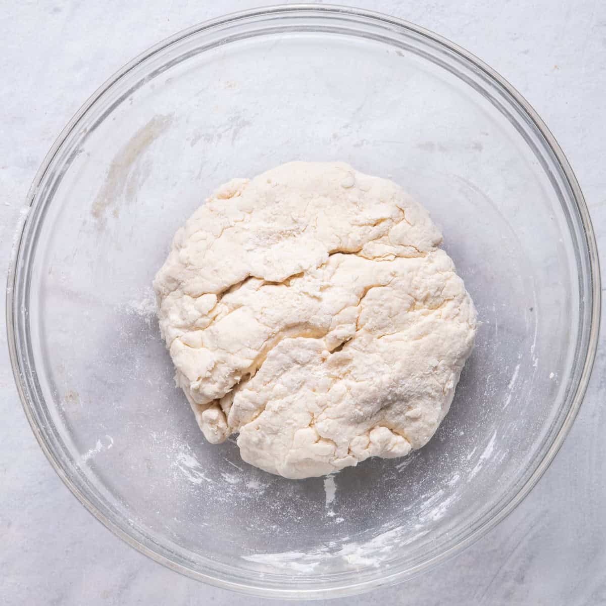 Flour mixture mixed with greek yogurt in bowl.