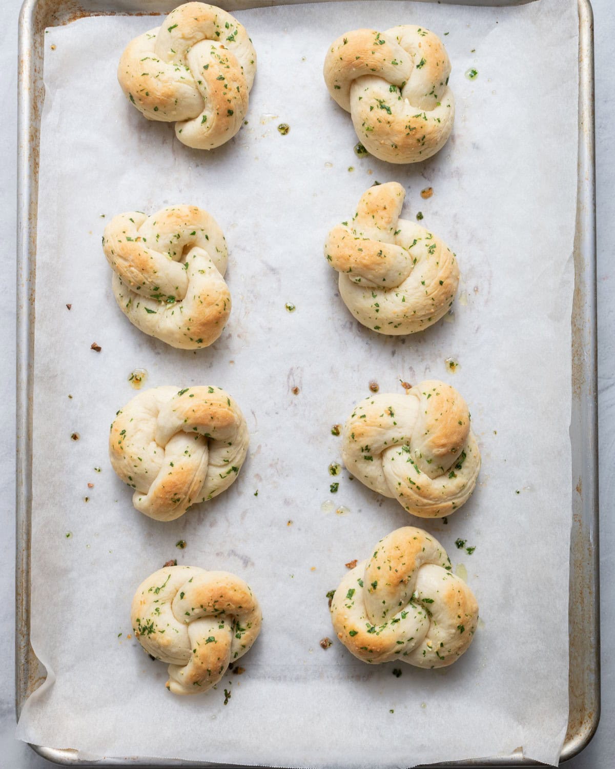 Baking sheet with garlic knots after baking.