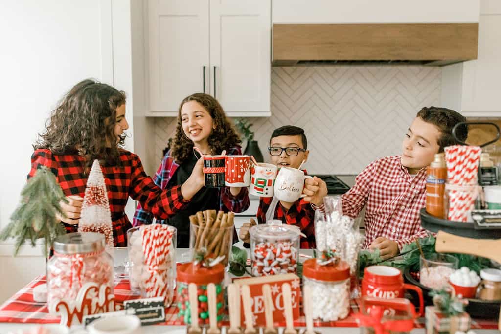 Kids cheering with hot cocoa mugs