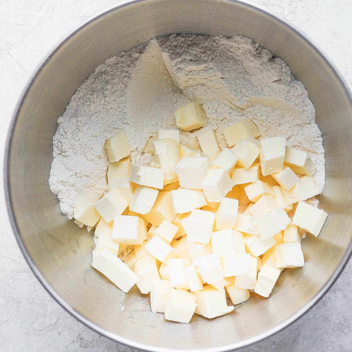 Cubed butter on top of flour mixture before processing.